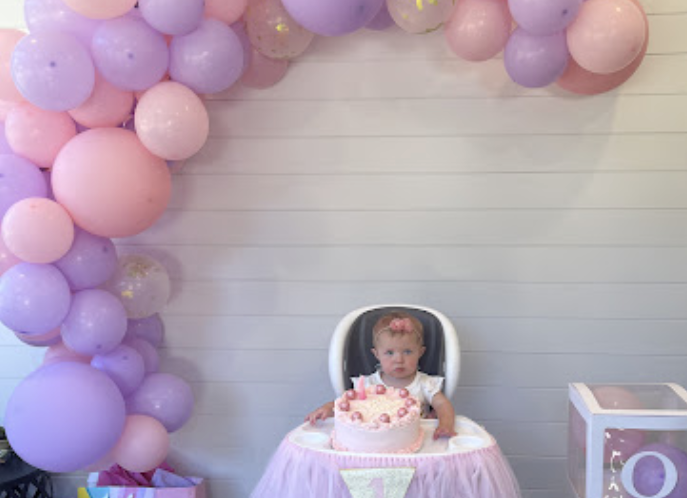 Baby with a pink cake